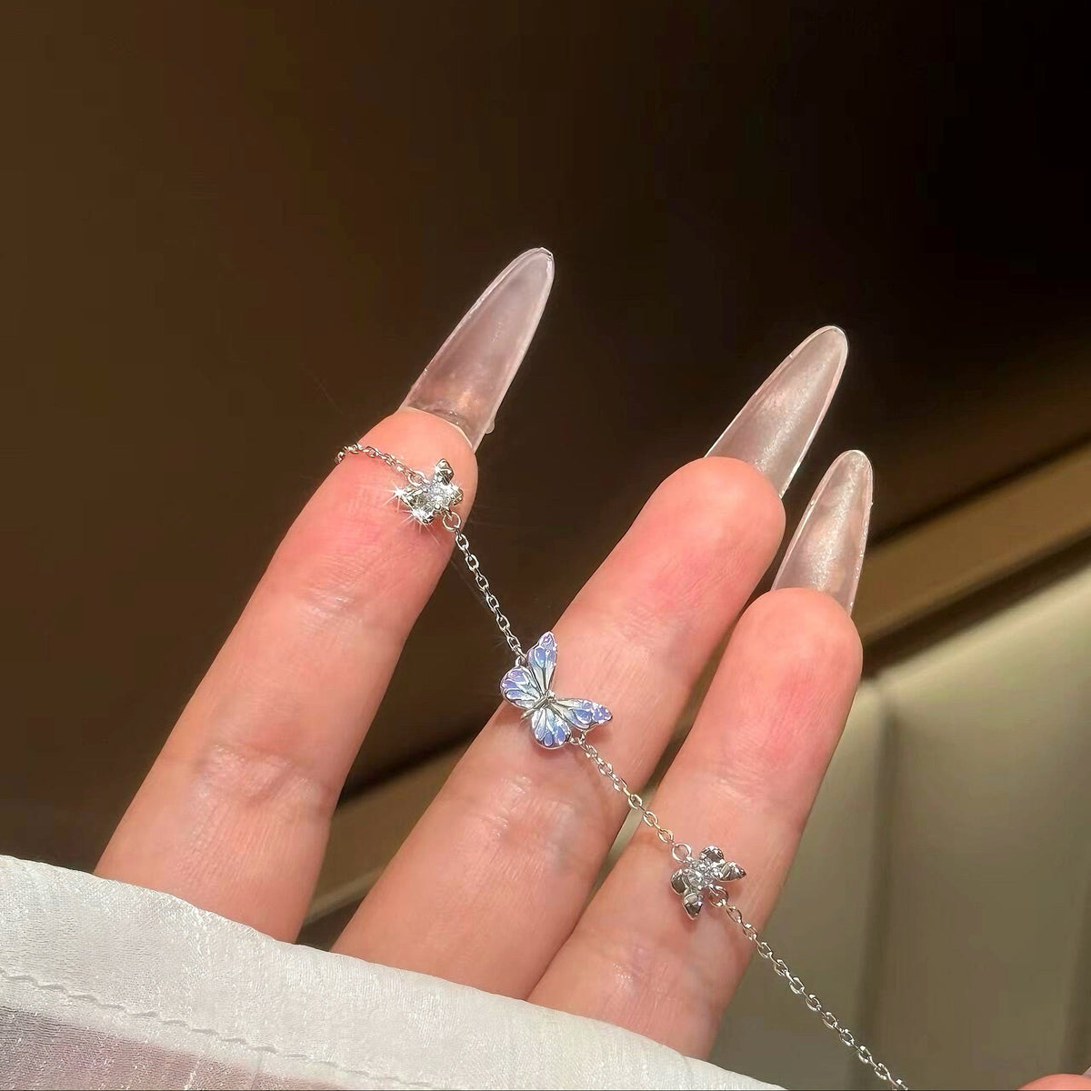 Close-up of the enamel butterfly and crystal flower charms