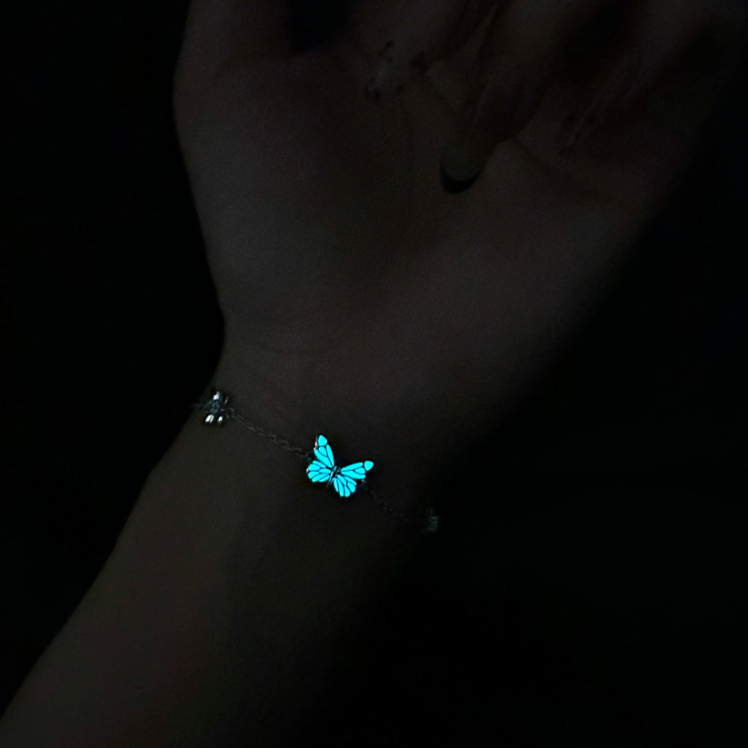 Butterfly bracelet glowing on the wrist at night