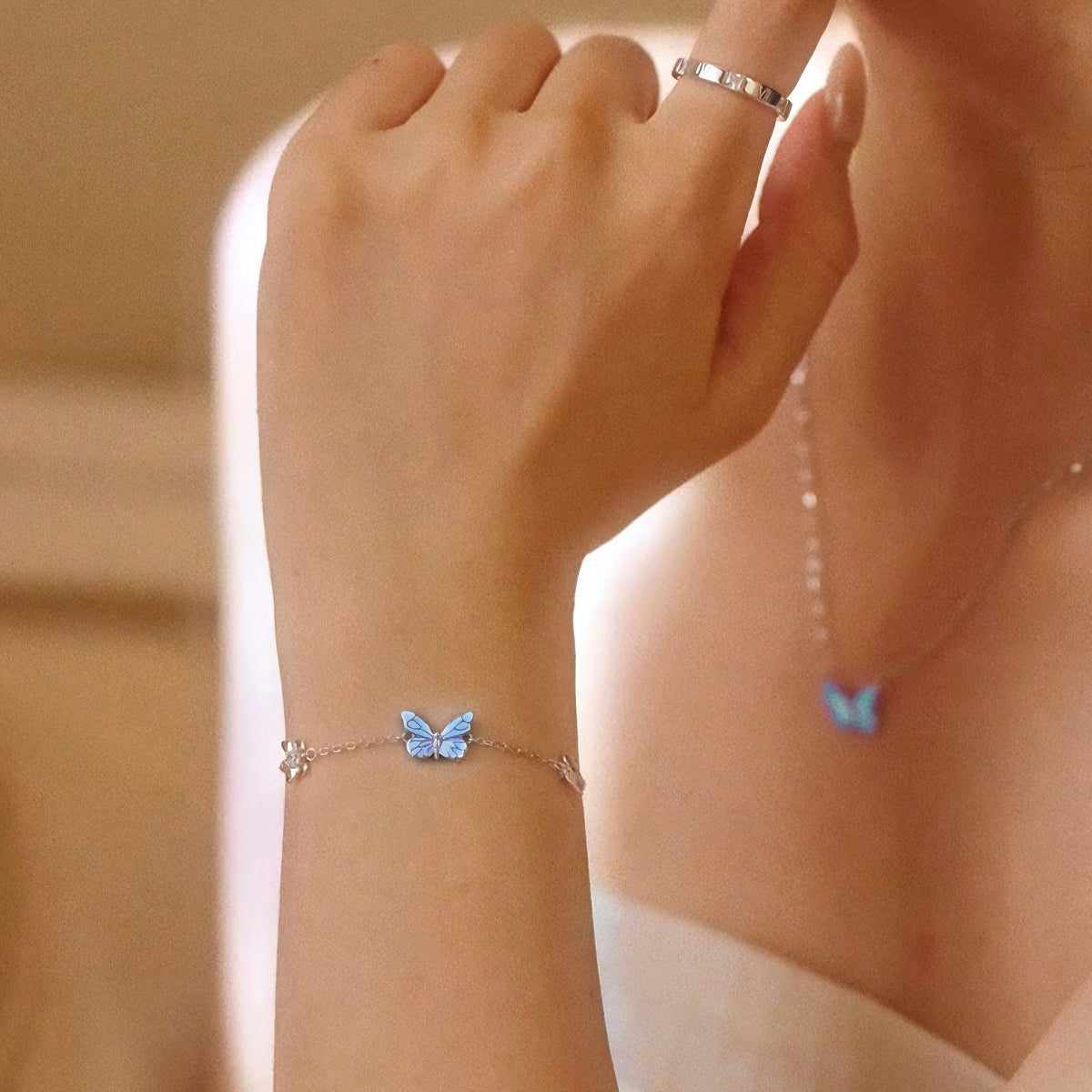 Butterfly bracelet and necklace worn together